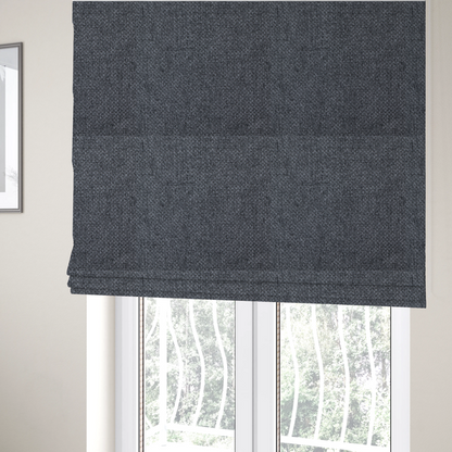 The fabric used to create these Roman blinds is a sturdy, woven upholstery fabric in a deep, sophisticated charcoal grey. Like the previous samples, it features a tight, consistent weave with an interlocking geometric pattern.