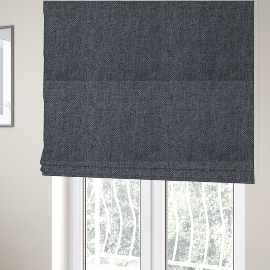 The fabric used to create these Roman blinds is a sturdy, woven upholstery fabric in a deep, sophisticated charcoal grey. Like the previous samples, it features a tight, consistent weave with an interlocking geometric pattern.
