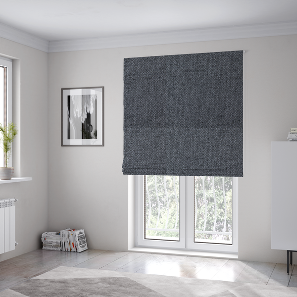 The fabric used to create these Roman blinds is a sturdy, woven upholstery fabric in a deep, sophisticated charcoal grey. Like the previous samples, it features a tight, consistent weave with an interlocking geometric pattern.
