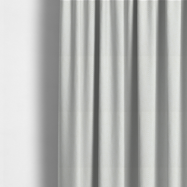 The fabric used to create these made-to-measure curtains is a tight, basket weave-style construction in an off-white or cream colour.