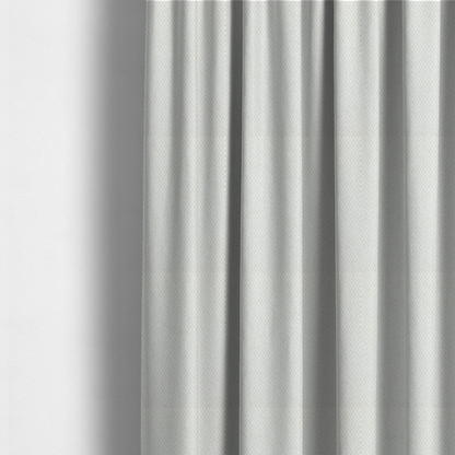 The fabric used to create these made-to-measure curtains is a tight, basket weave-style construction in an off-white or cream colour.