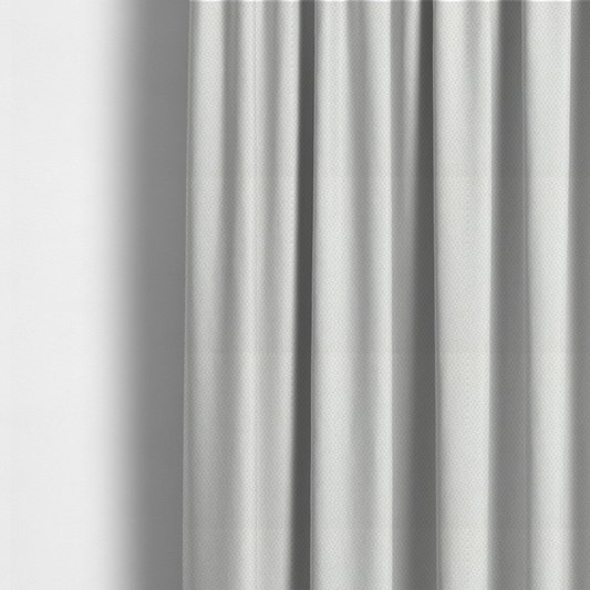 The fabric used to create these made-to-measure curtains is a tight, basket weave-style construction in an off-white or cream colour.