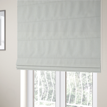 The fabric used to create these Roman blinds is a tight, basket weave-style construction in an off-white or cream colour.