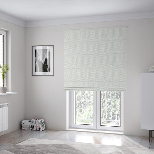 The fabric used to create these Roman blinds is a tight, basket weave-style construction in an off-white or cream colour.