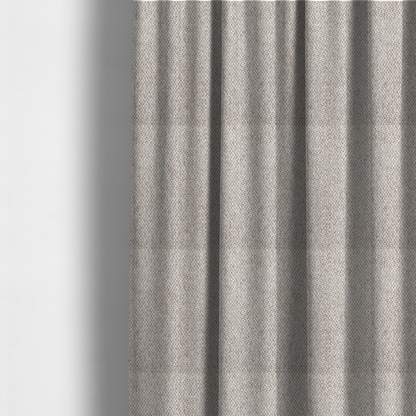 The fabric used to create these made-to-measure curtains is a multi-tonal, textured basket weave in a sophisticated blend of beige, taupe, and off-white yarns.