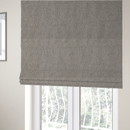 The fabric used to create these Roman blinds is a fabric features a tight, structured basket weave in a versatile, mid-tone grey.