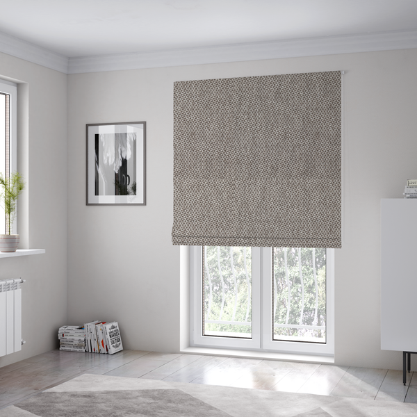 The fabric used to create these Roman blinds is a fabric features a tight, structured basket weave in a versatile, mid-tone grey.
