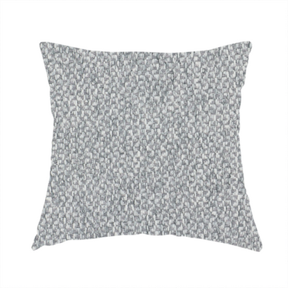 The fabric used to create this handmade cushion is a fabric features a dimensional, textured weave in a cool, soft grey.