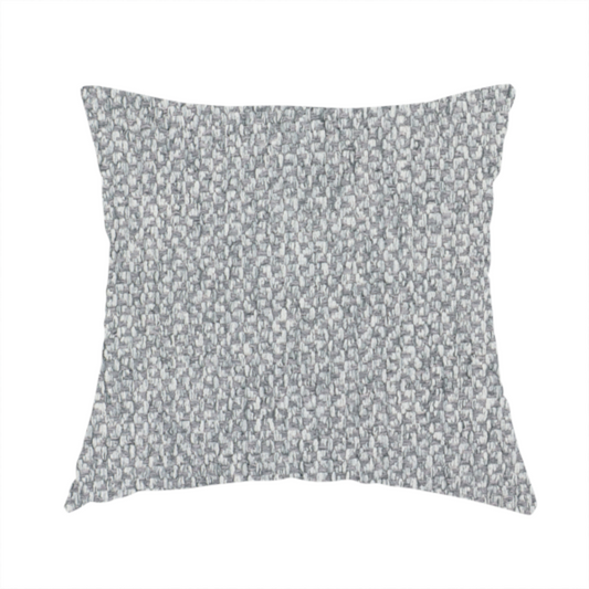 The fabric used to create this handmade cushion is a fabric features a dimensional, textured weave in a cool, soft grey.