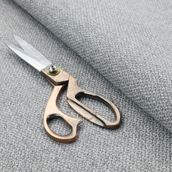 This fabric features a dimensional, textured weave in a cool, soft grey.
