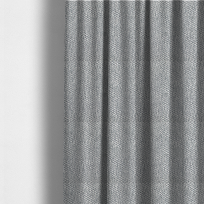 The fabric used to create these made-to-measure curtains is a fabric features a dimensional, textured weave in a cool, soft grey.