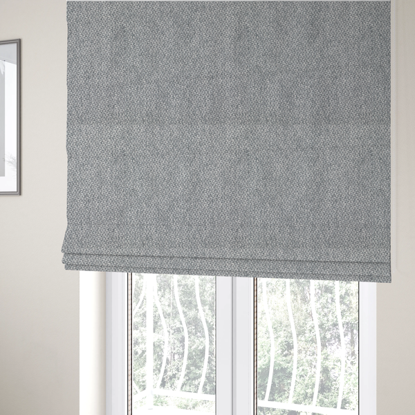 The fabric used to create these Roman blinds is a fabric features a dimensional, textured weave in a cool, soft grey.