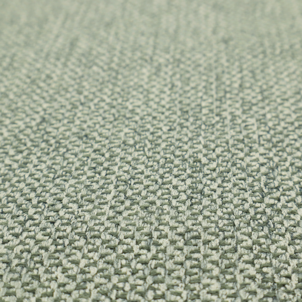 This fabric features a tight, structured basket weave in a soft, muted sage green.