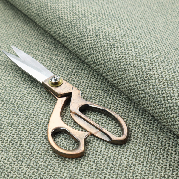 This fabric features a tight, structured basket weave in a soft, muted sage green.
