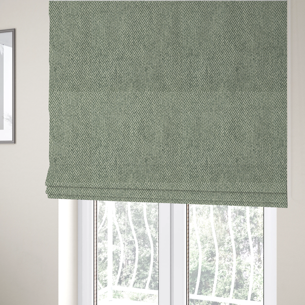 The fabric used to create these Roman blinds is a fabric features a tight, structured basket weave in a soft, muted sage green.