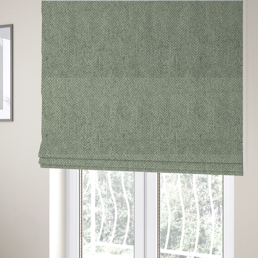 The fabric used to create these Roman blinds is a fabric features a tight, structured basket weave in a soft, muted sage green.