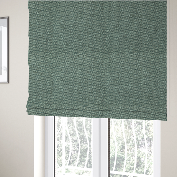 The fabric used to create these Roman blinds is a fabric features a tight, structured basket weave in a vibrant, deep green.