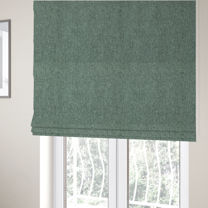 The fabric used to create these Roman blinds is a fabric features a tight, structured basket weave in a vibrant, deep green.