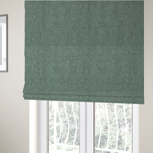 The fabric used to create these Roman blinds is a fabric features a tight, structured basket weave in a vibrant, deep green.