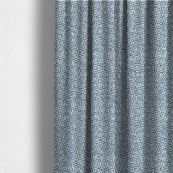 The fabric used to create these made-to-measure curtains is a fabric features a tight, structured basket weave in a soft, cool-toned sky blue.