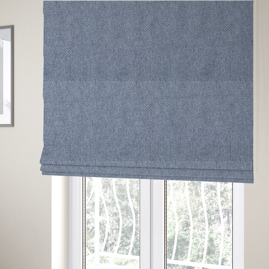 The fabric used to create these Roman blinds is a fabric features a tight, structured basket weave in a rich, mid-tone slate blue.