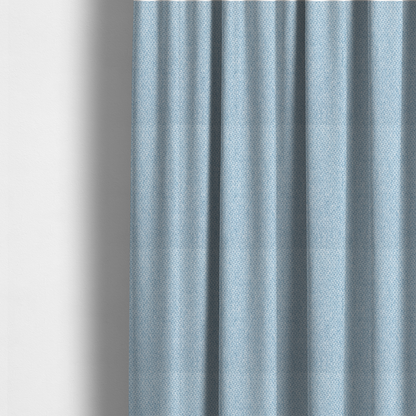 The fabric used to create these made-to-measure curtains is a fabric features a tight, structured basket weave in a soft, airy powder blue.