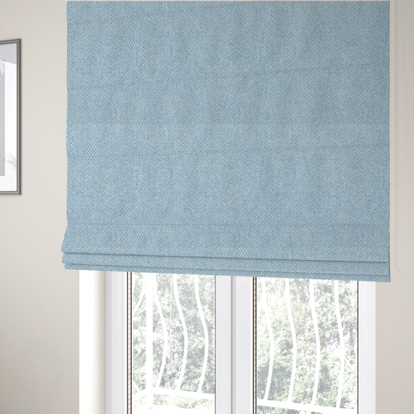 The fabric used to create these Roman blinds is a fabric features a tight, structured basket weave in a soft, airy powder blue.