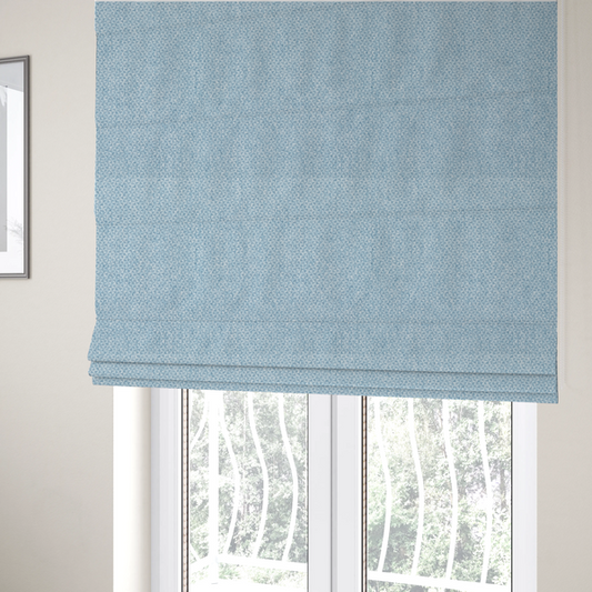 The fabric used to create these Roman blinds is a fabric features a tight, structured basket weave in a soft, airy powder blue.