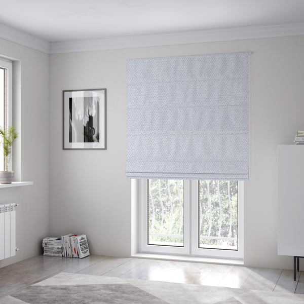 The fabric used to create these Roman blinds is a fabric features a tight, structured basket weave in a sophisticated, cool-toned silver.