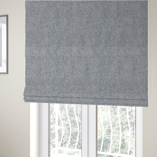 The fabric used to create these Roman blinds is a fabric features a tight, structured basket weave in a versatile, deep charcoal grey.