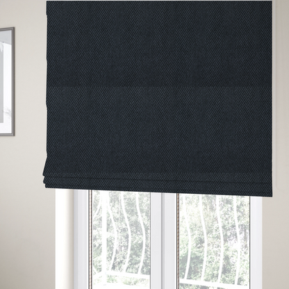 The fabric used to create these Roman blinds is a fabric features a tight, structured basket weave in a deep, moody charcoal or near-black tone.