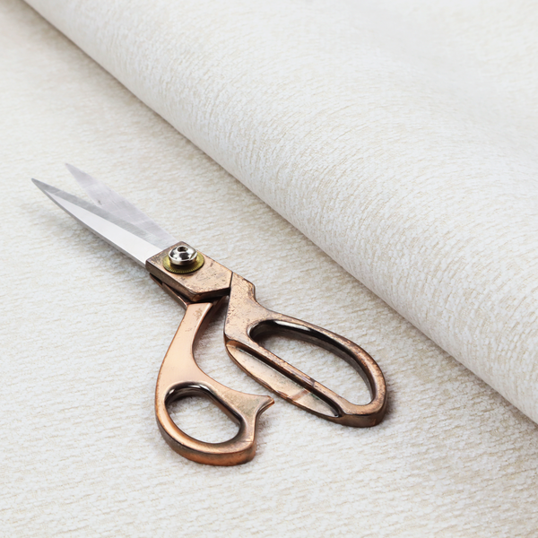 A textured, off-white or cream-coloured weave. It has a bouclé-like or chunky, nubby appearance with a slightly irregular, multidimensional surface that gives it a cosy, organic, and tactile quality.