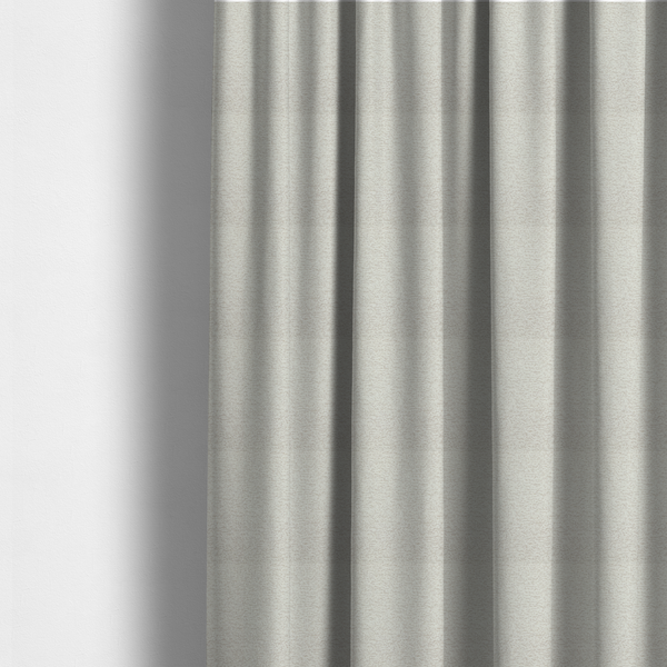 The fabric used to create these made-to-measure curtains is a sophisticated, multi-tonal neutral weave. It features a blend of cream, beige, and soft taupe threads, creating a subtle, heathered effect.