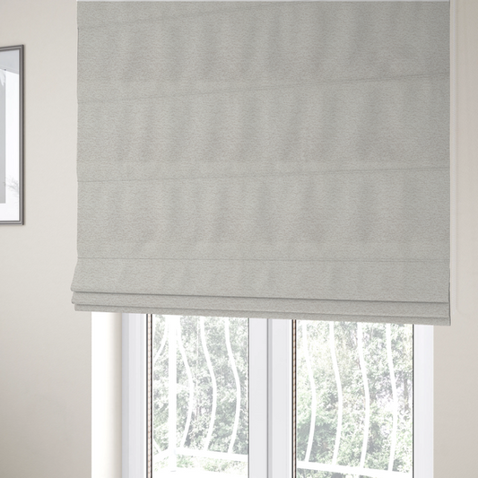 The fabric used to create these Roman blinds is a sophisticated, multi-tonal neutral weave. It features a blend of cream, beige, and soft taupe threads, creating a subtle, heathered effect.