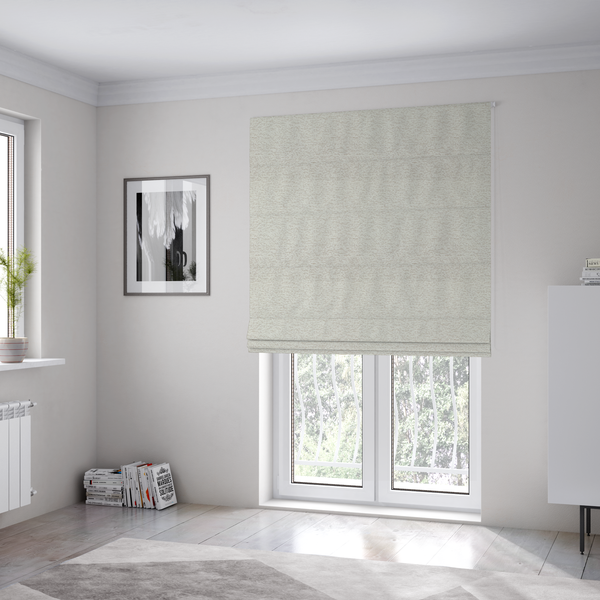 The fabric used to create these Roman blinds is a sophisticated, multi-tonal neutral weave. It features a blend of cream, beige, and soft taupe threads, creating a subtle, heathered effect.