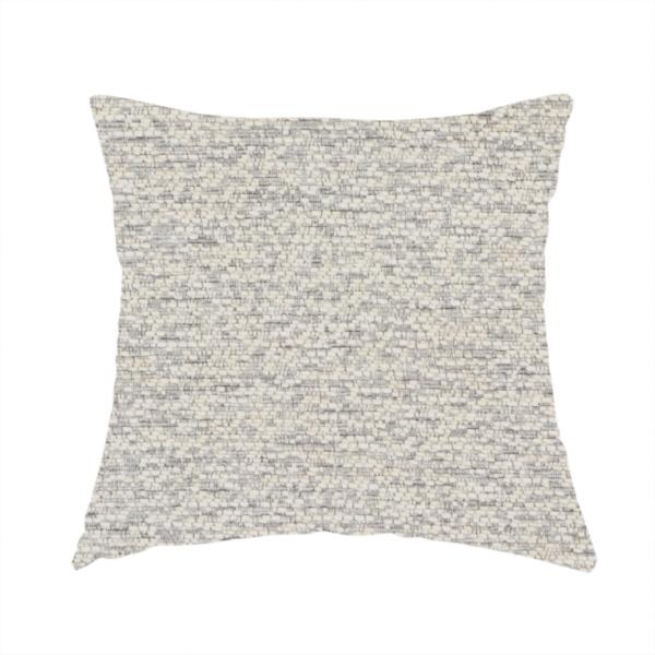 The fabric used to create this handmade cushion is a sophisticated, two-tone textured weave that blends cool grey and soft cream yarns.