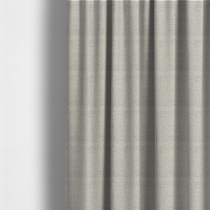 The fabric used to create these made-to-measure curtains is a sophisticated, two-tone textured weave that blends cool grey and soft cream yarns.