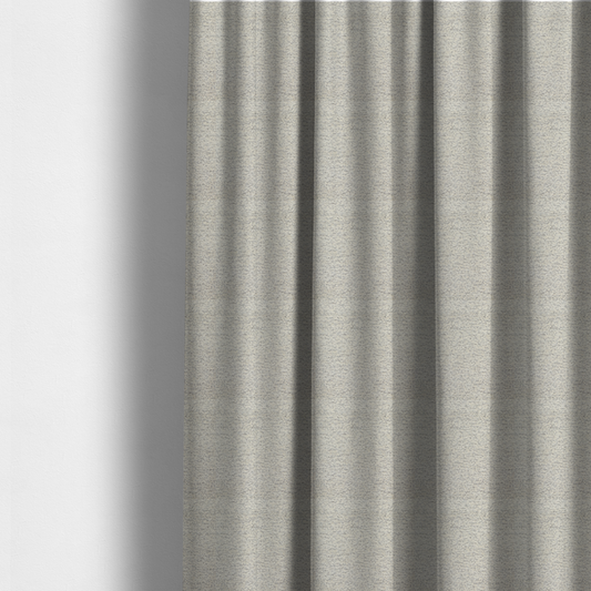 The fabric used to create these made-to-measure curtains is a sophisticated, two-tone textured weave that blends cool grey and soft cream yarns.