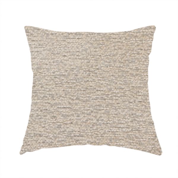The fabric used to create this handmade cushion is a warm, earthy neutral weave that masterfully blends light cream, tan, and soft grey tones. It has a complex, nubby texture with an intricate, multidimensional surface that feels both substantial and inviting.