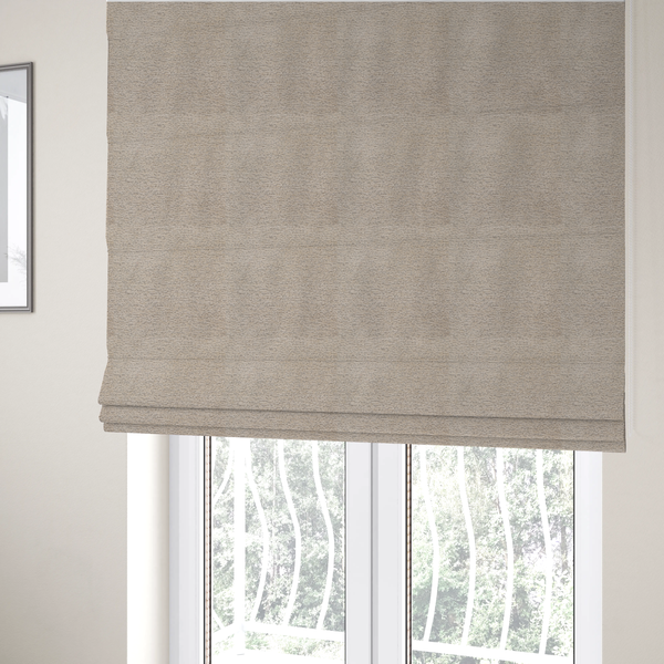 The fabric used to create these Roman blinds is a warm, earthy neutral weave that masterfully blends light cream, tan, and soft grey tones. It has a complex, nubby texture with an intricate, multidimensional surface that feels both substantial and inviting.