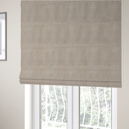 The fabric used to create these Roman blinds is a warm, earthy neutral weave that masterfully blends light cream, tan, and soft grey tones. It has a complex, nubby texture with an intricate, multidimensional surface that feels both substantial and inviting.
