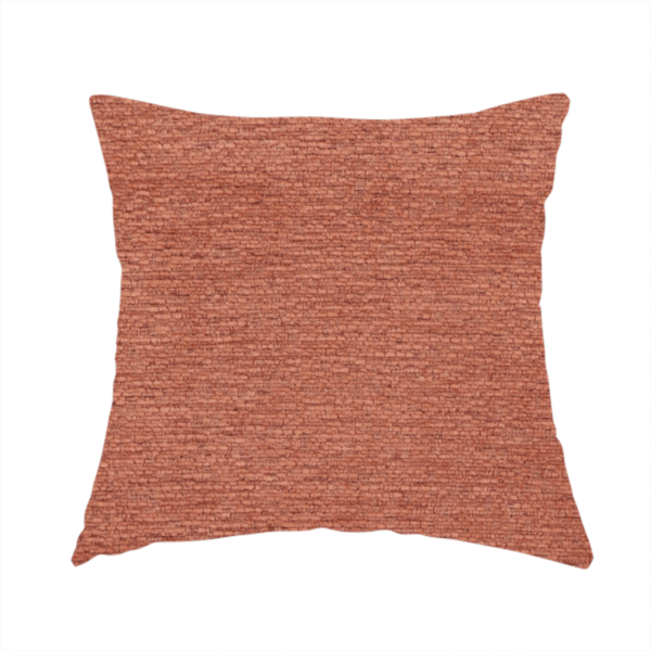 The fabric used to create these handmade cushions is a vibrant, warm terracotta or rust-coloured weave. It features a dense, structured texture with horizontal ribbing and a consistent, slightly nubby finish that adds depth and character.