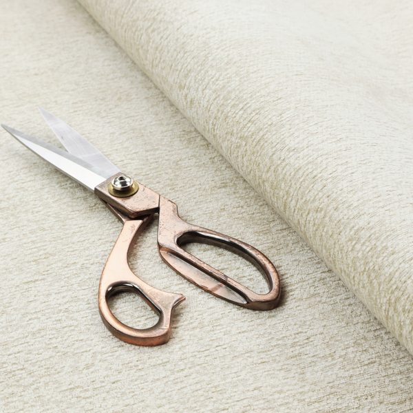 A light, creamy ivory weave with a refined, textured appearance. It is crafted with a dense, nubby construction that creates a subtle horizontal ribbing effect, providing both visual dimension and a soft, tactile quality.