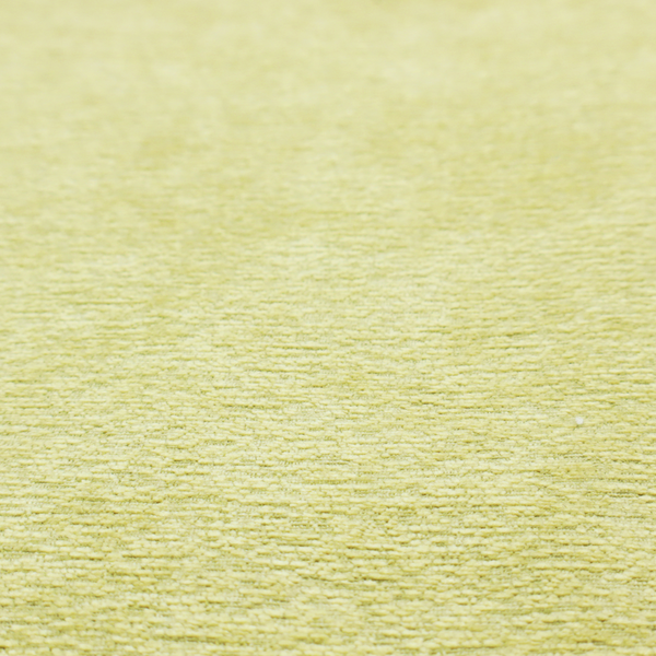 a fresh, vibrant chartreuse-green weave with a sophisticated, textured finish. It is crafted with a dense, nubby construction that creates a subtle horizontal ribbing effect, providing both visual dimension and a soft, inviting tactile quality.