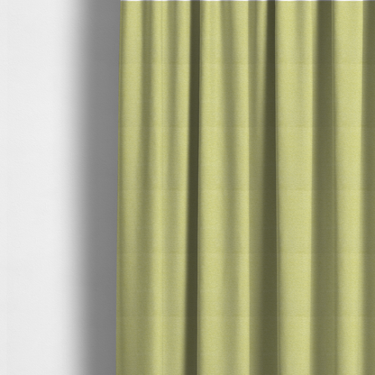 The fabric used to create these made-to-measure curtains is a fresh, vibrant chartreuse-green weave with a sophisticated, textured finish. It is crafted with a dense, nubby construction that creates a subtle horizontal ribbing effect, providing both visual dimension and a soft, inviting tactile quality.