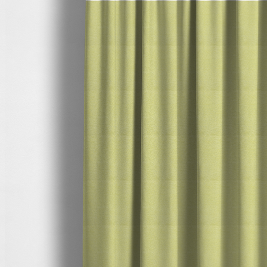 The fabric used to create these made-to-measure curtains is a fresh, vibrant chartreuse-green weave with a sophisticated, textured finish. It is crafted with a dense, nubby construction that creates a subtle horizontal ribbing effect, providing both visual dimension and a soft, inviting tactile quality.