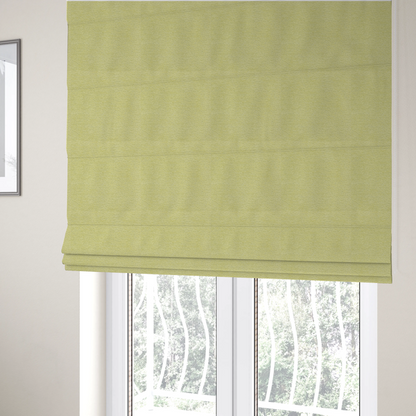 The fabric used to create these Roman blinds is a fresh, vibrant chartreuse-green weave with a sophisticated, textured finish. It is crafted with a dense, nubby construction that creates a subtle horizontal ribbing effect, providing both visual dimension and a soft, inviting tactile quality.