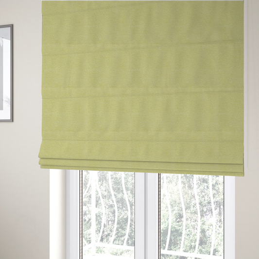 The fabric used to create these Roman blinds is a fresh, vibrant chartreuse-green weave with a sophisticated, textured finish. It is crafted with a dense, nubby construction that creates a subtle horizontal ribbing effect, providing both visual dimension and a soft, inviting tactile quality.