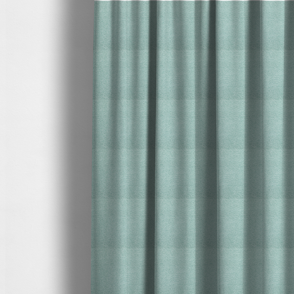 The fabric used to create these made-to-measure curtains is a serene, cool-toned seafoam or soft teal weave with a sophisticated, textured finish.