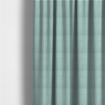 The fabric used to create these made-to-measure curtains is a serene, cool-toned seafoam or soft teal weave with a sophisticated, textured finish.